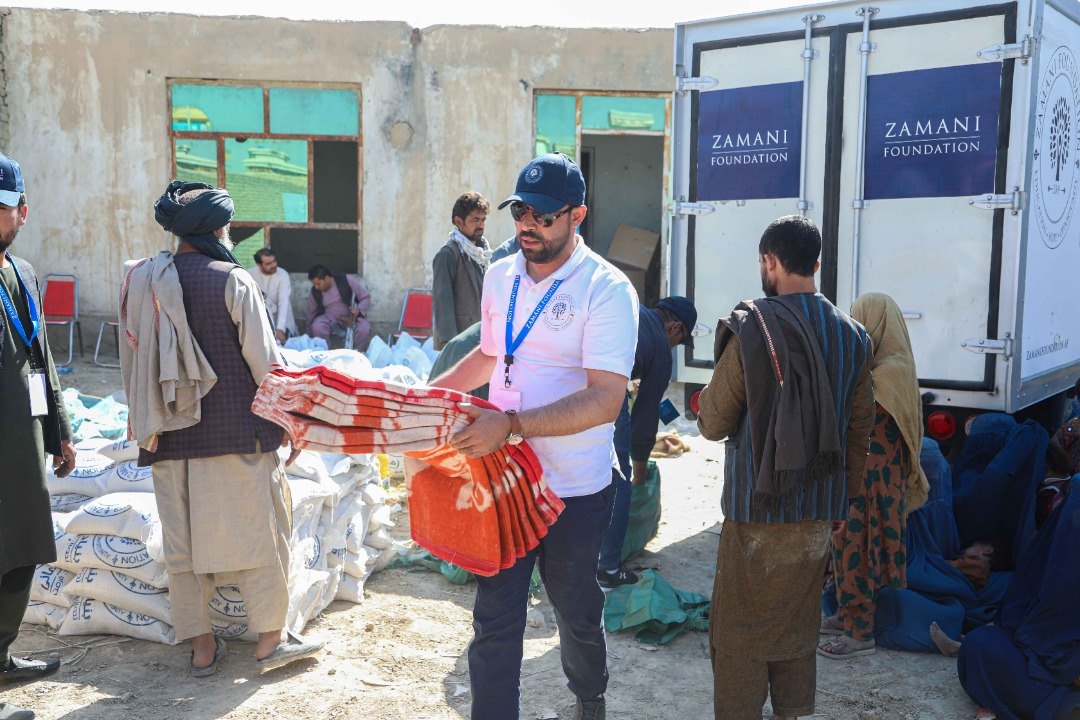Zamani Foundation volunteers distribute blankets and food from a branded truck